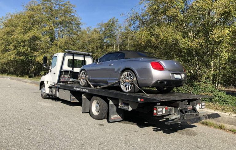 Convertible secured on a flatbed tow truck