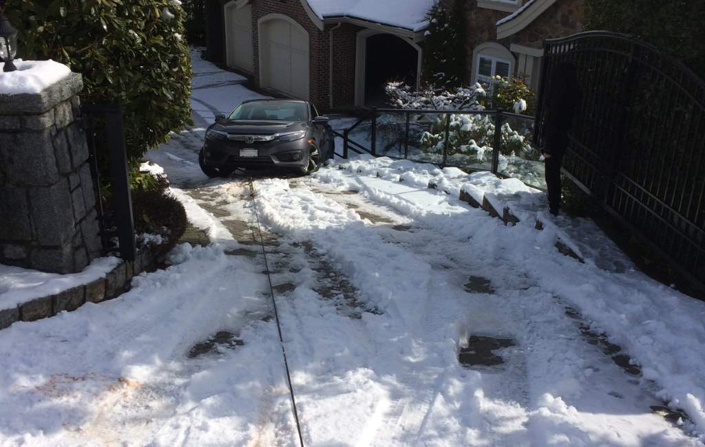 Sedan being winched up a driveway