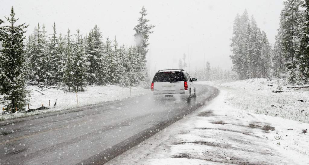 SUV driving on a snowy mountain road